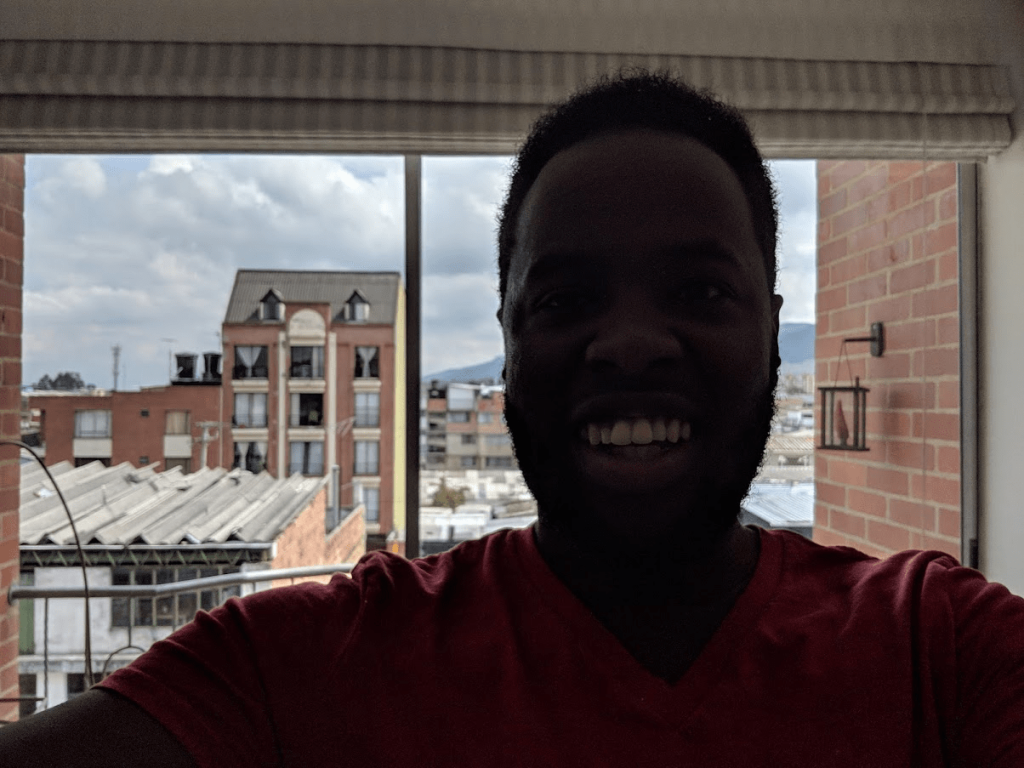 Selfie on the apartment balcony...man did I need a haircut and some braces back in those days